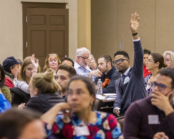 News Voices event attendees raising hands