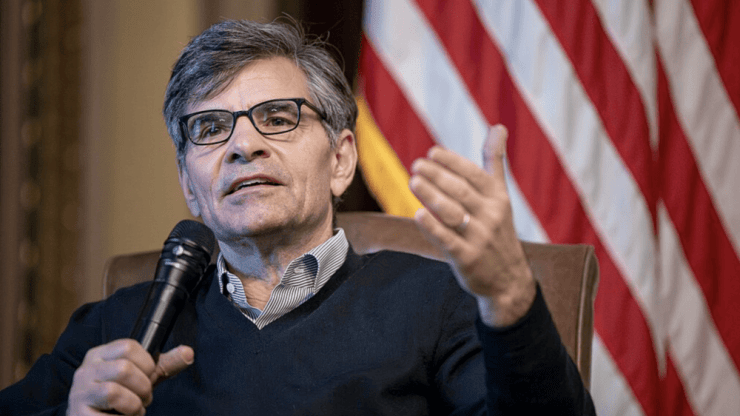 George Stephanopoulos holding a microphone