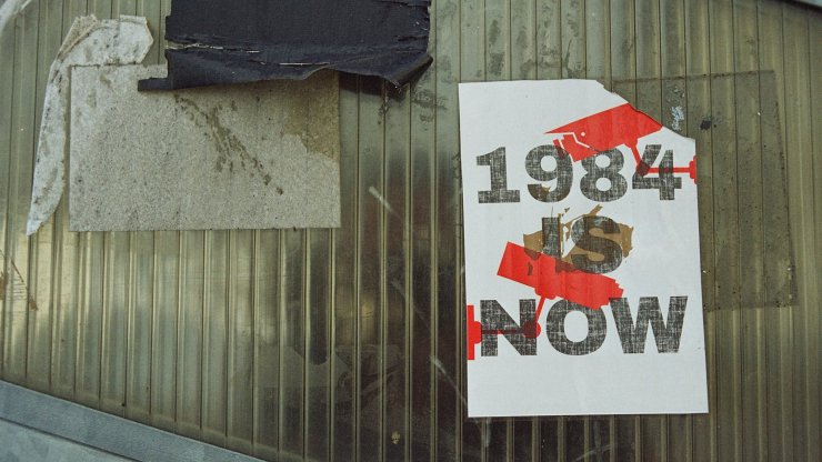 A poster reading "1984 Is Now"