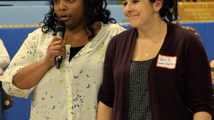 Two women speaking at microphone