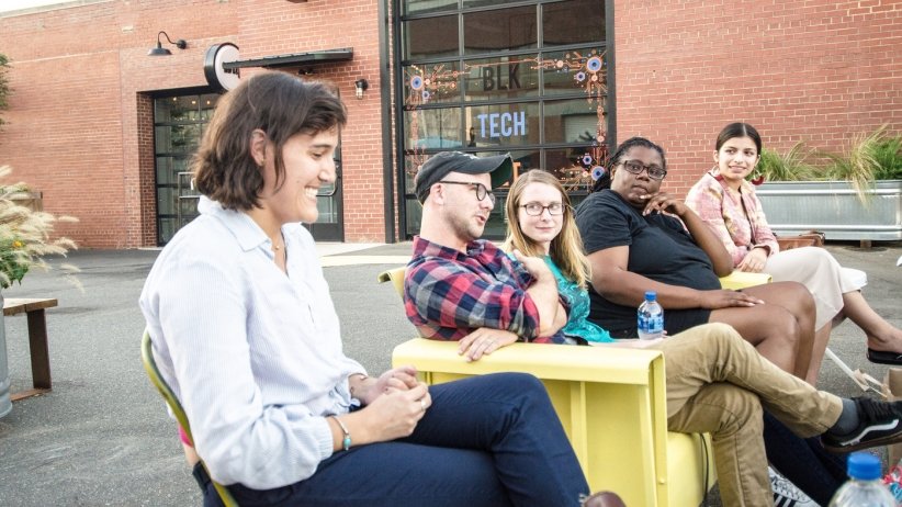 Group shot of people sitting outside and talking