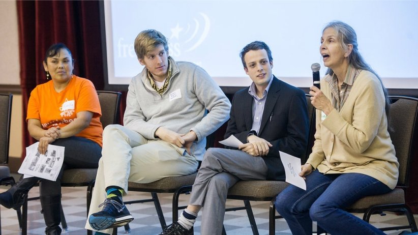 Four panelists on stage