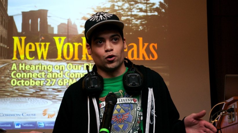 Man with headphones speaks into the microphone