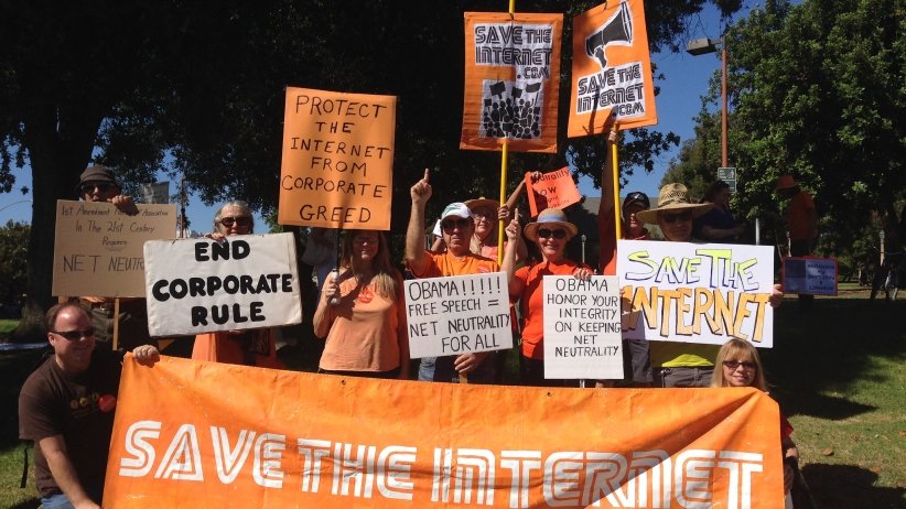 Activists holding "Save the Internet" banner