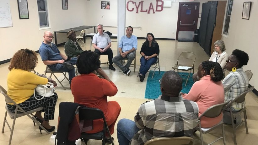 Residents and reporters at an event in Camden