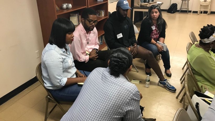 People sitting in a small cluster and talking
