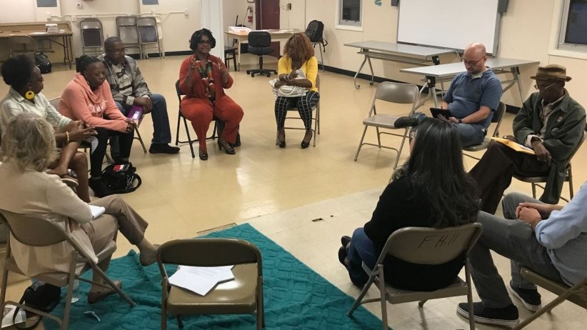 Residents and reporters at an event in Camden