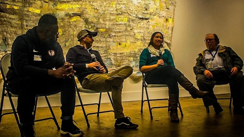 Four people participating in panel discussion during Charlotte event