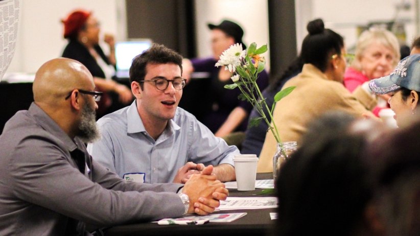 People talking at table during Charlotte event