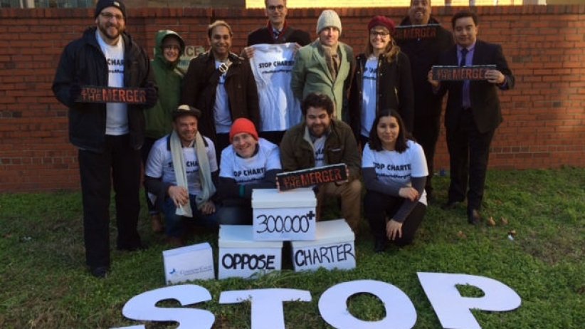 Coalition members with petition boxes and a large sign reading "Stop"