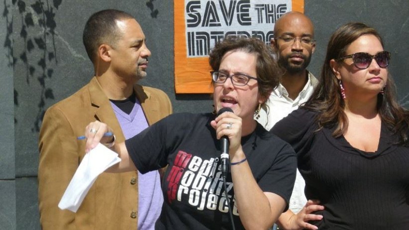 Hannah Sassaman of the Media Mobilizing Project speaks into a microphone