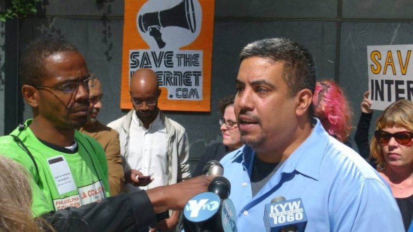 Free Press' Joseph Torres speaks into a microphone
