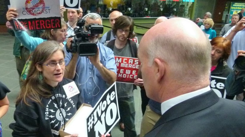 Free Press Field Director Mary Alice Crim delivering petitions to a Comcast representative.
