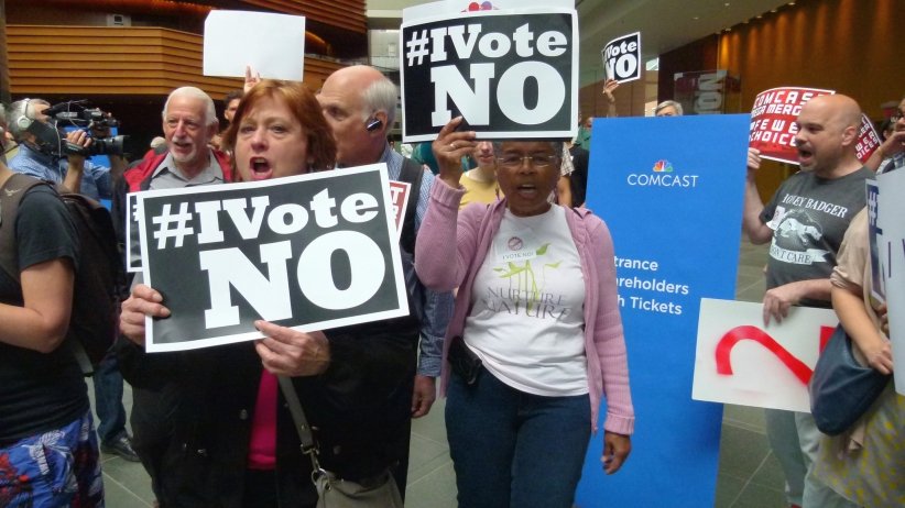 Women holding "I vote no!" signs