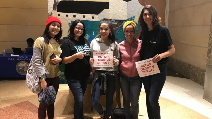 Free Press Action staffers Jessica and Nilda with three other women opposing the merger