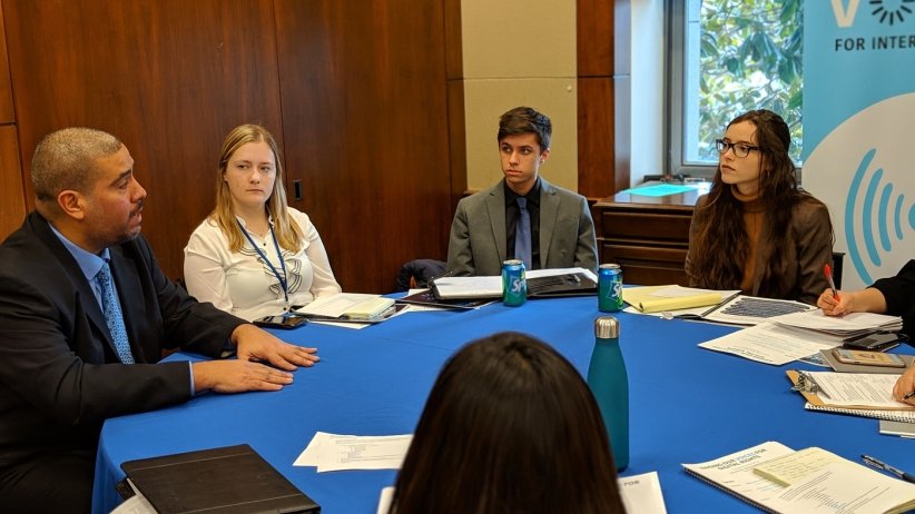Free Press Action staffer at a table with congressional staffers