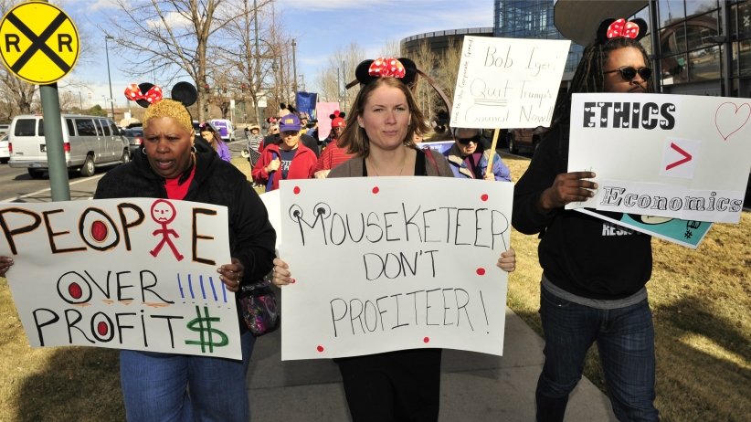 Three women marching with mouseketeer hats