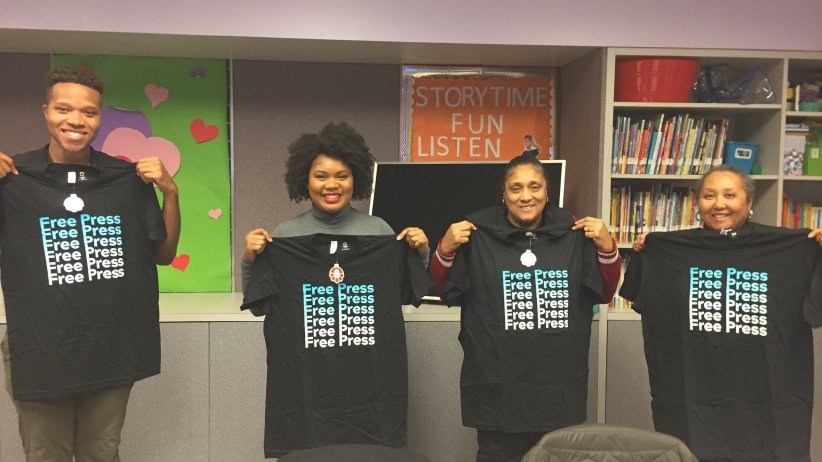 Four library-series participants display their new Free Press T-shirts