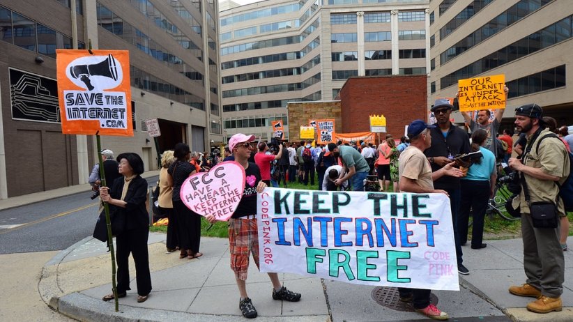 Activists holding banner reading "Keep the internet free"