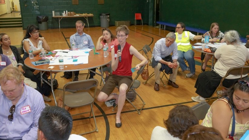 Woman at table speaking into microphone