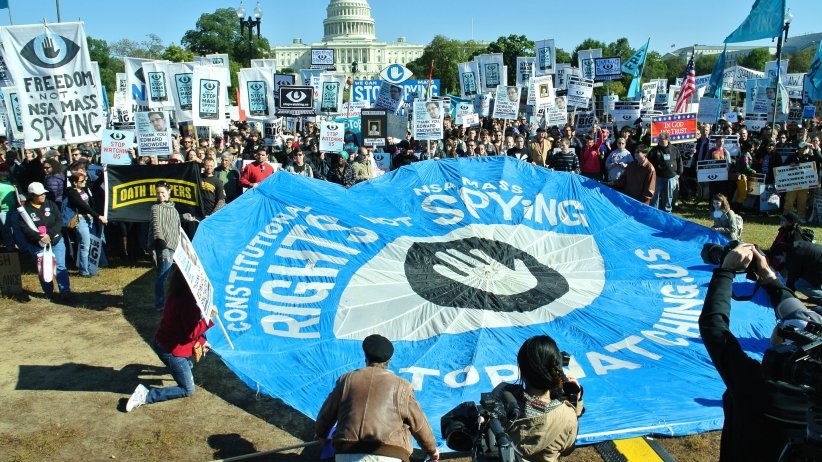 Activists putting StopWatching.Us banner on ground, with U.S. Capitol in the background