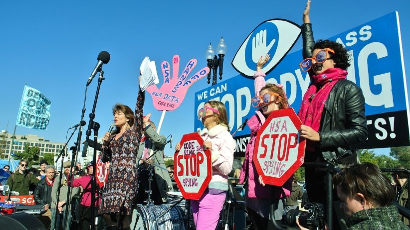 Anti-surveillance activists speaking into the microphone on stage
