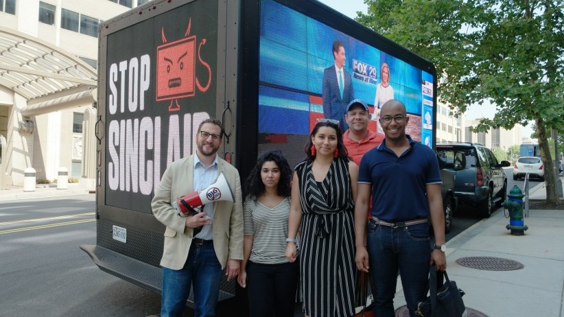 Activists standing beside the truck displaying the video billboard