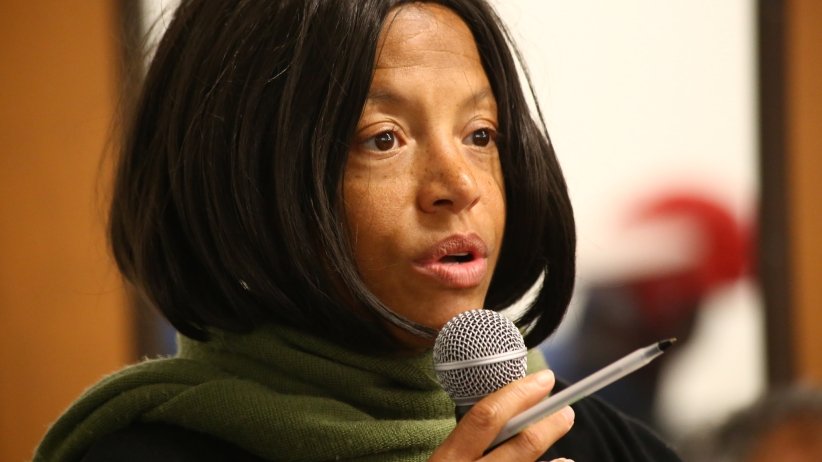 Woman speaking into microphone