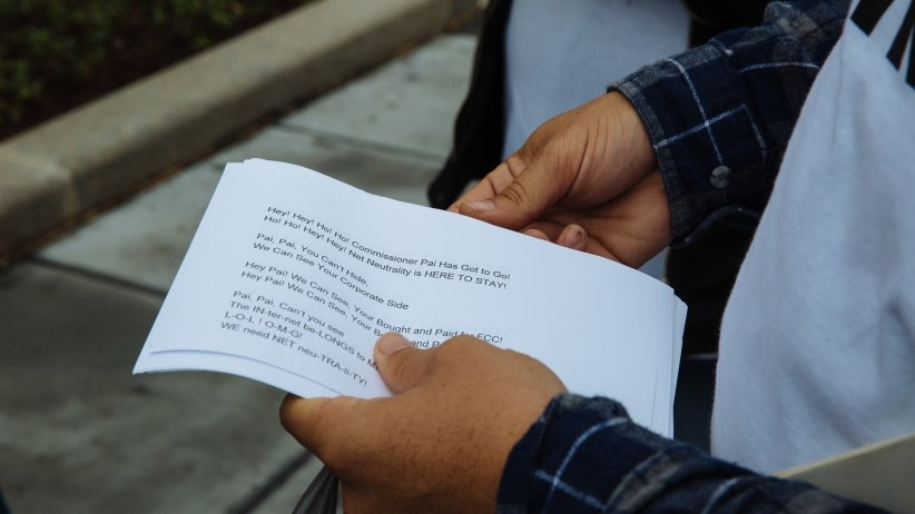 Activist holding Net Neutrality chant lyrics