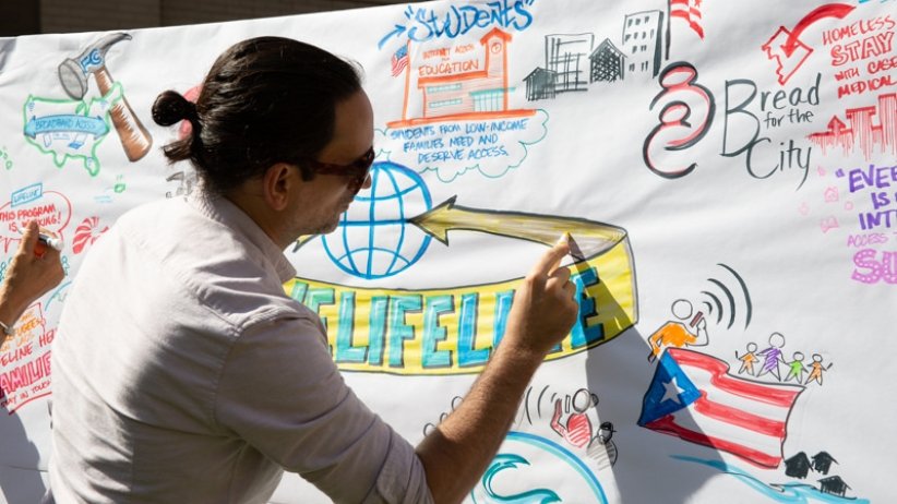 Man writing on poster featuring comments about Lifeline