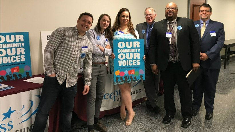 Free Press Action Fund members holding News Voices signs