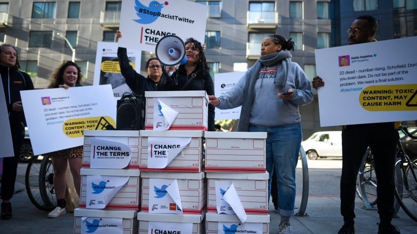 Activists standing before boxes of petitions