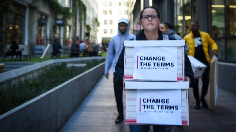 Free Press' Jessica J. Gonzalez holding boxes of petitions