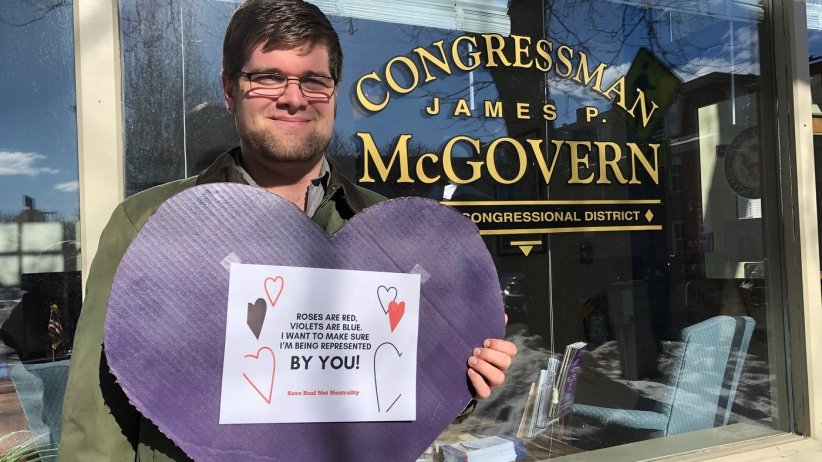 Net Neutrality activist holds a valentine outside Rep. McGovern's office