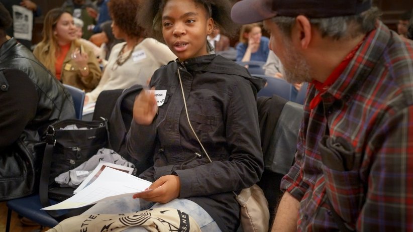 Young woman talking to man