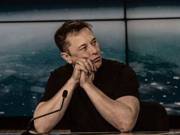 Elon Musk sitting at a table