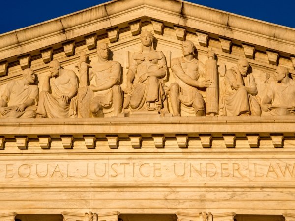 The top of the Supreme Court building, featuring statues and the phrase "Equal Justice Under Law"