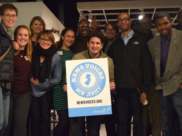 Group of people holding a News Voices: New Jersey sign