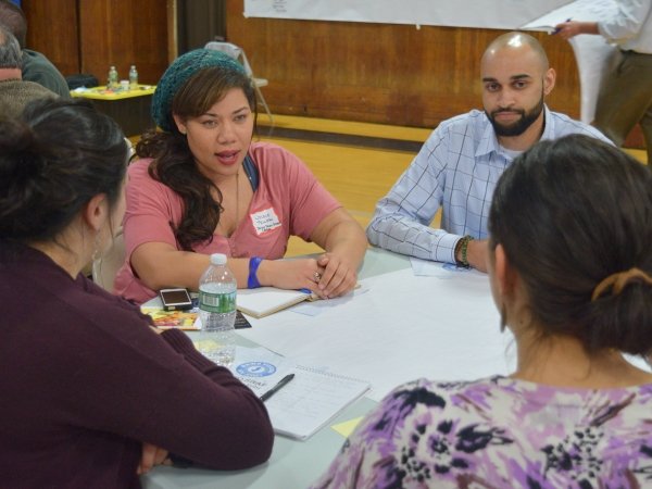 Woman talking at table with three other people