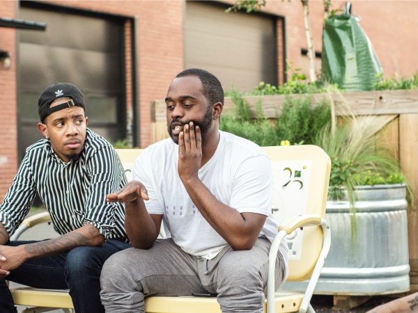 Two men sitting side by side