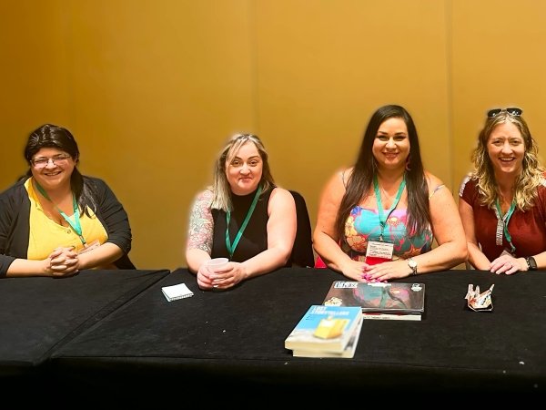 Free Press' Vanessa Maria Graber and other advocates sitting at a table at the Association in Journalism and Mass Communication conference