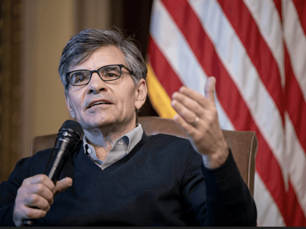 George Stephanopoulos holding a microphone