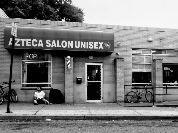 Man outside the Azteca Salon Unisex in New Brunswick