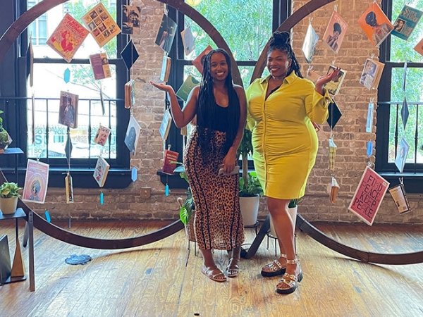 Diamond Hardiman and Venneikia Williams in front of the Black Future Newsstand exhibit, which explores Black liberation 