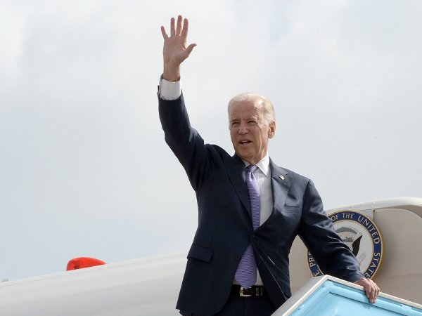 President Joe Biden waves before boarding a plane