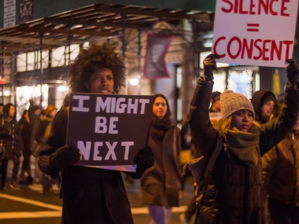 Black Lives Matter protest, with activists holding signs reading "I might be next" and "Silence = consent"