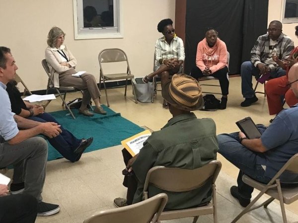 Residents and reporters at an event in Camden