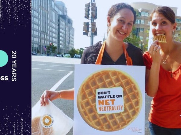 Free Press Chief of Staff Misty Perez Truedson and Free Press alum Jenn Topper holding waffles and a sign reading "Don't waffle on Net Neutrality" outside FCC headquarters