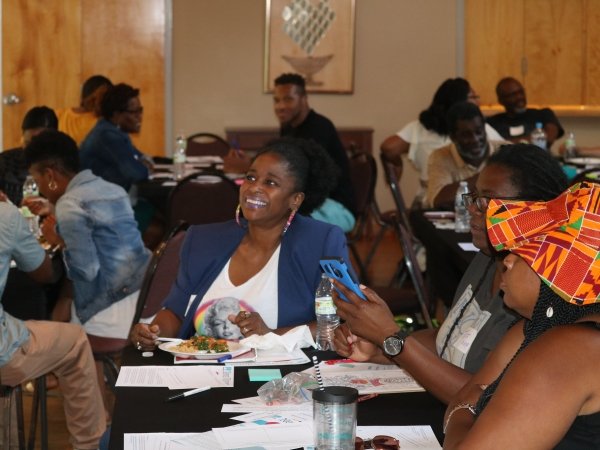 Woman smiling at table with other people