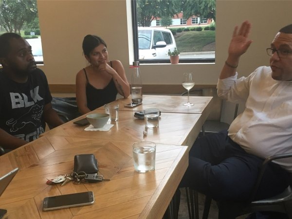 Residents and reporters talking at a table